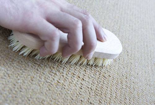 Nettoyage de tapis avec une brosse dure