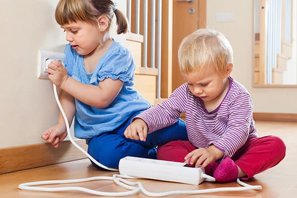 Children play with a surge protector