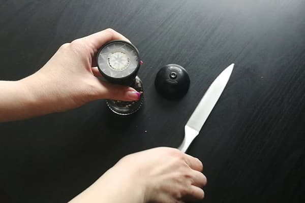 Opening a disposable mill with a knife